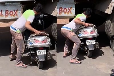 Terjebak Kemacetan, Pengendara Sepeda Motor Ini Cari Jalan Pintas dari Bawah Truk